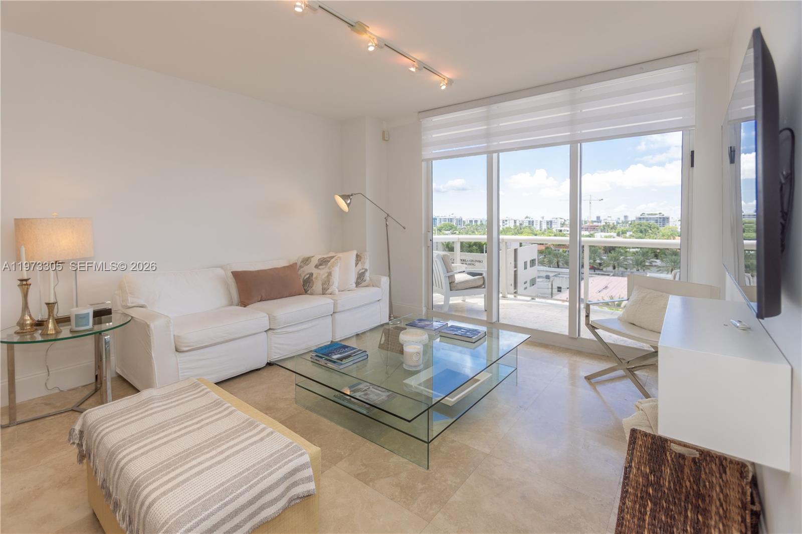 9595 Collins Avenue, Unit N6F Surfside, FL 33154 - Photo 15 of 26 a living room with furniture a rug and a large window