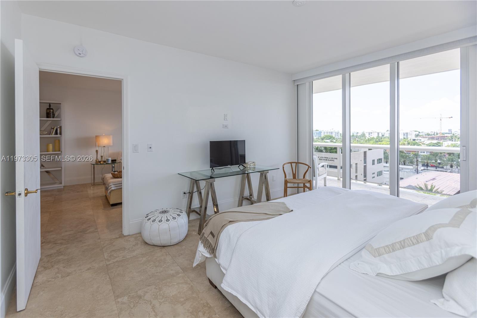 9595 Collins Avenue, Unit N6F Surfside, FL 33154 - Photo 20 of 26 a bedroom with bed and glass walk in closet