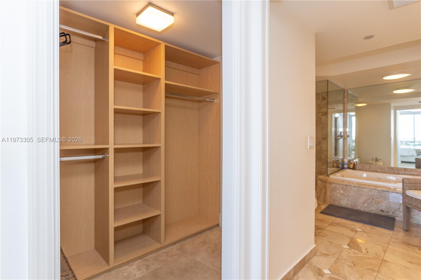 9595 Collins Avenue, Unit N6F Surfside, FL 33154 - Photo 23 of 26 a view of walk in closet with empty racks