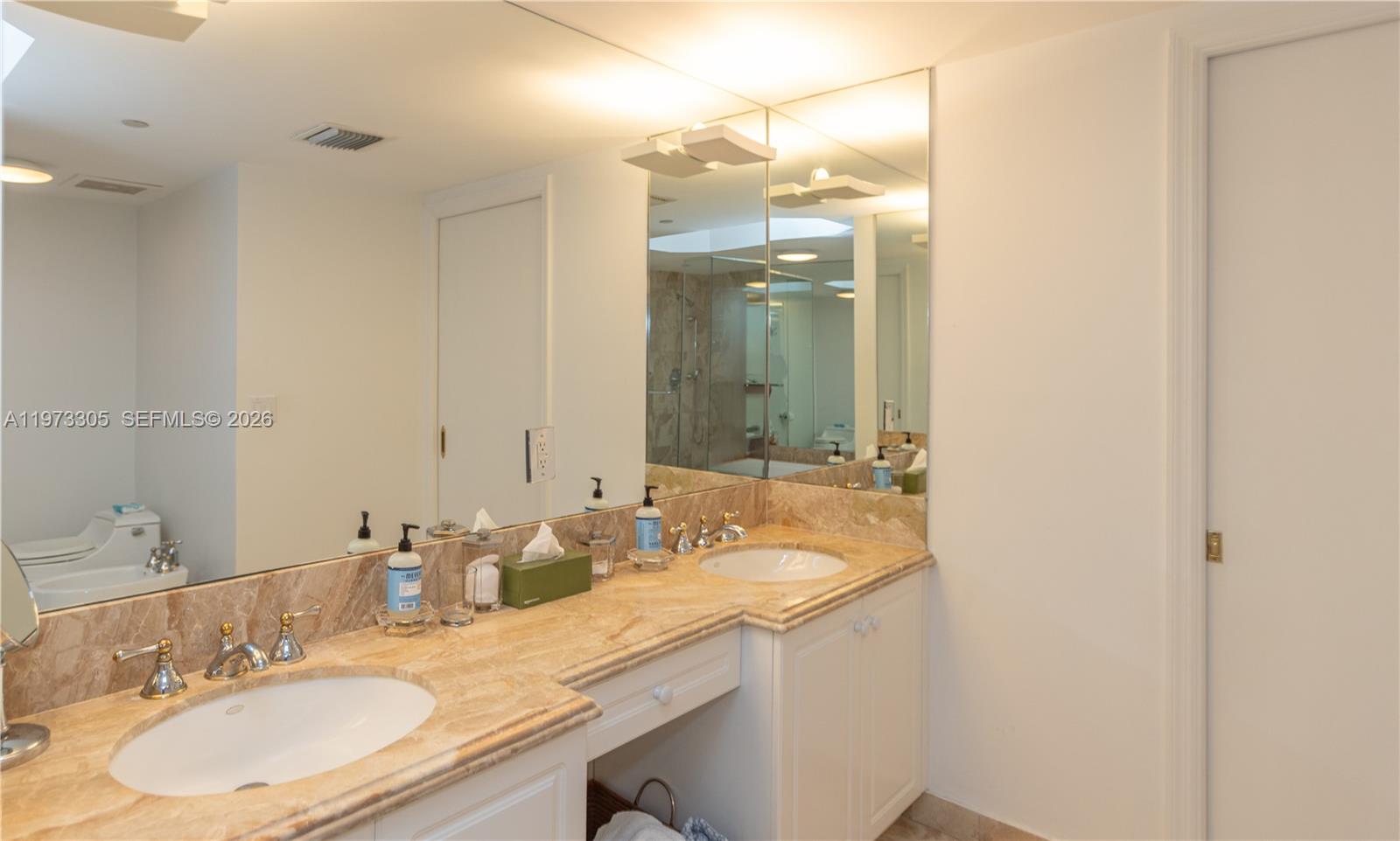 9595 Collins Avenue, Unit N6F Surfside, FL 33154 - Photo 25 of 26 a bathroom with a granite countertop sink and a mirror
