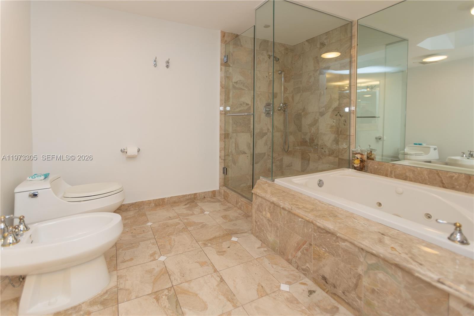 9595 Collins Avenue, Unit N6F Surfside, FL 33154 - Photo 26 of 26 a bathroom with a granite countertop sink a toilet and shower