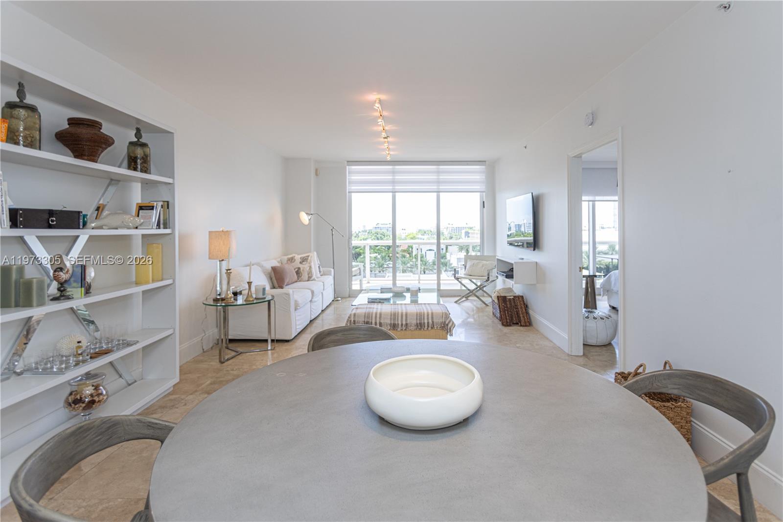 9595 Collins Avenue, Unit N6F Surfside, FL 33154 - Photo 4 of 26 a room with a bed a table and a large window