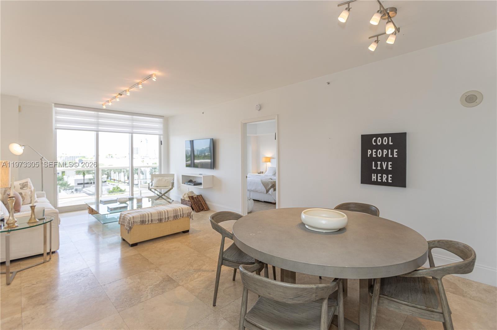 9595 Collins Avenue, Unit N6F Surfside, FL 33154 - Photo 6 of 26 a view of a dining room with furniture and a large window