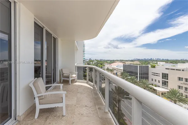 a view of a balcony with table and chairs