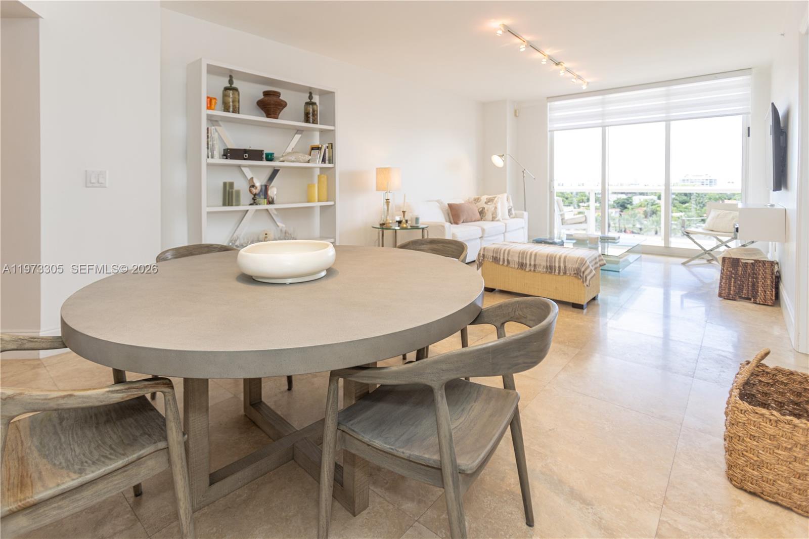 9595 Collins Avenue, Unit N6F Surfside, FL 33154 - Photo 10 of 26 a view of a dining room with furniture and a large window