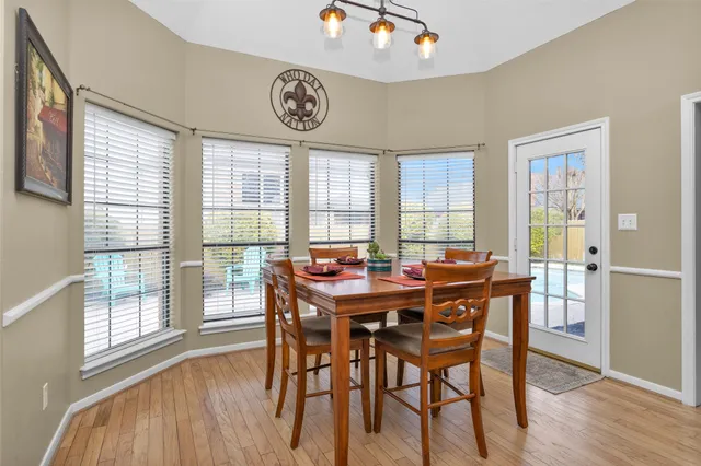 a view of a dining room with furniture window and wooden floor