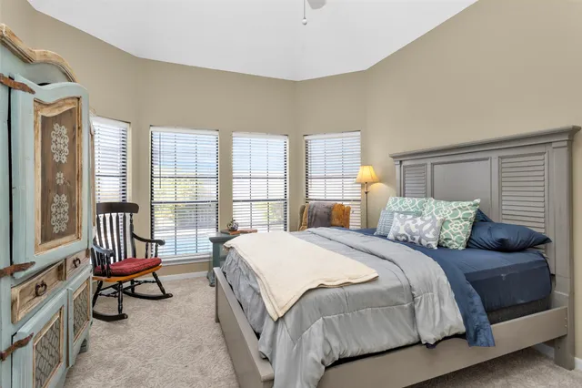 a bed room with a bed and a chair