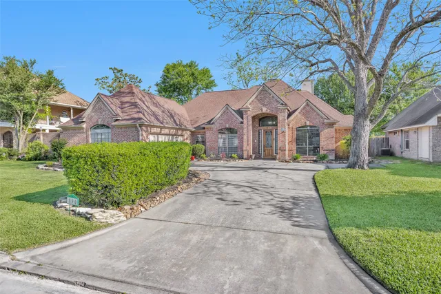 a front view of a house with a garden and plants