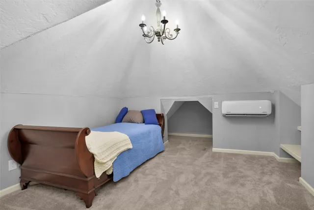 a bedroom with a bed and a chandelier fan