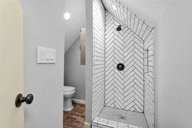 a bathroom with a sink and mirror with toilet