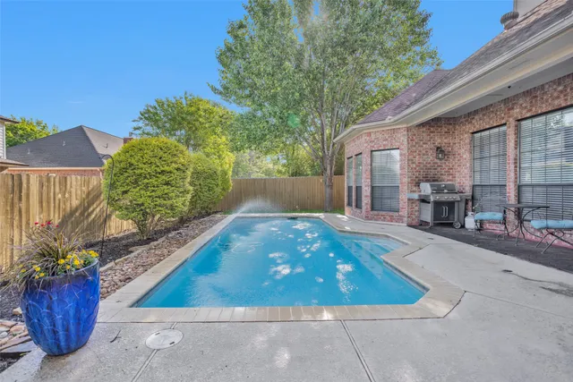 a view of backyard with plants and outdoor seating