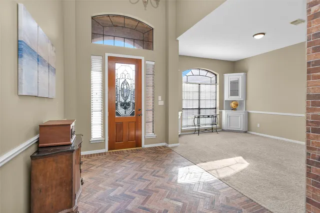 a view of a livingroom with wooden furniture and windows