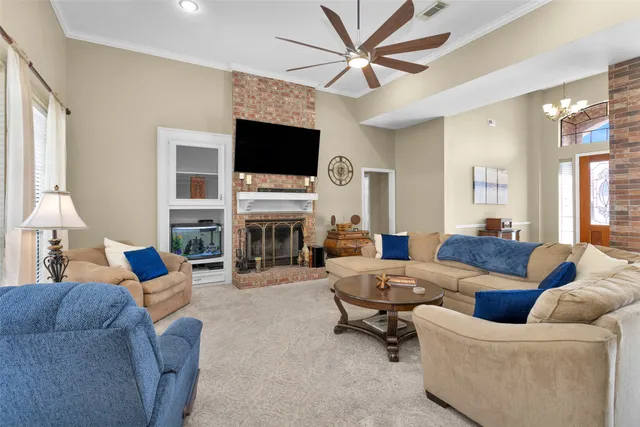 a living room with furniture a fireplace and a flat screen tv