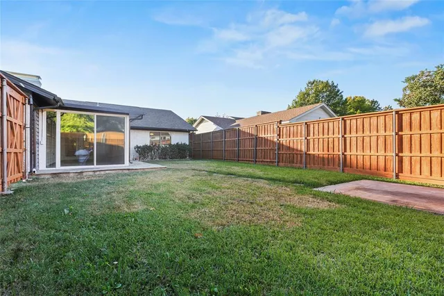 a view of a backyard with a garden and deck
