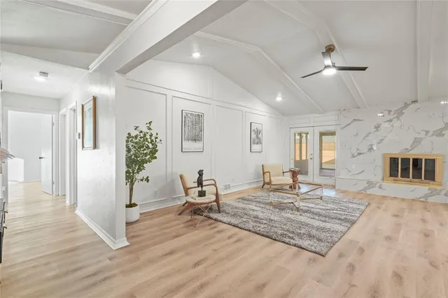 a living room with furniture rug and a chandelier