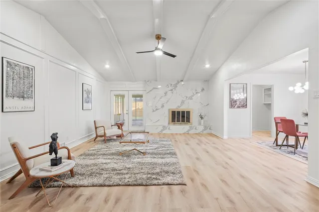 a living room with furniture and a chandelier