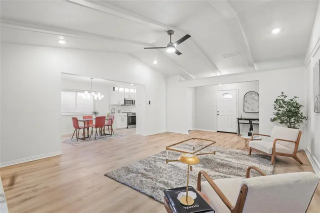 a living room with furniture and wooden floor