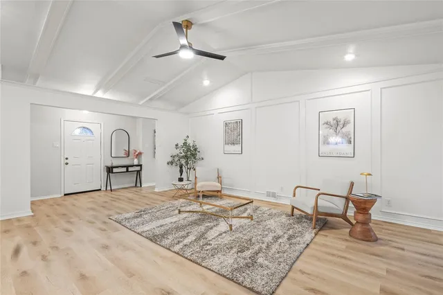 a view of a room with wooden floor and furniture
