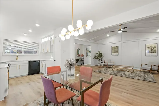 a view of a dining room with furniture and a chandelier