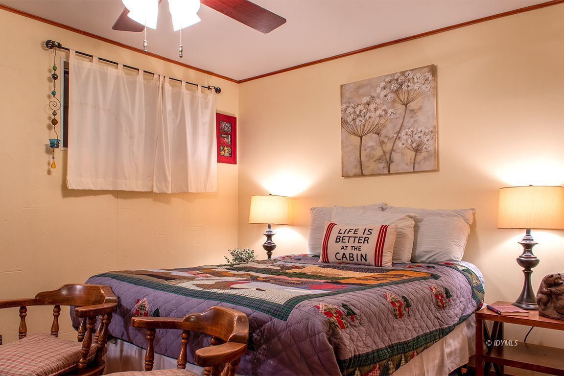 24730 High Grove Road Idyllwild, CA 92549 - Photo 13 of 24 a bedroom with a bed and a painting on the wall