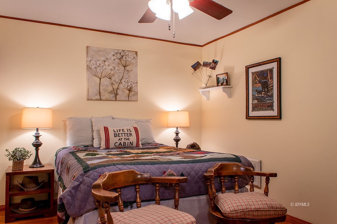 24730 High Grove Road Idyllwild, CA 92549 - Photo 14 of 24 a bedroom with a bed and a lamp on dresser