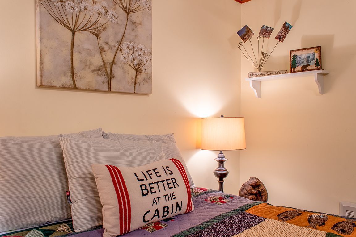 24730 High Grove Road Idyllwild, CA 92549 - Photo 15 of 24 a bedroom with a bed and painting on the wall