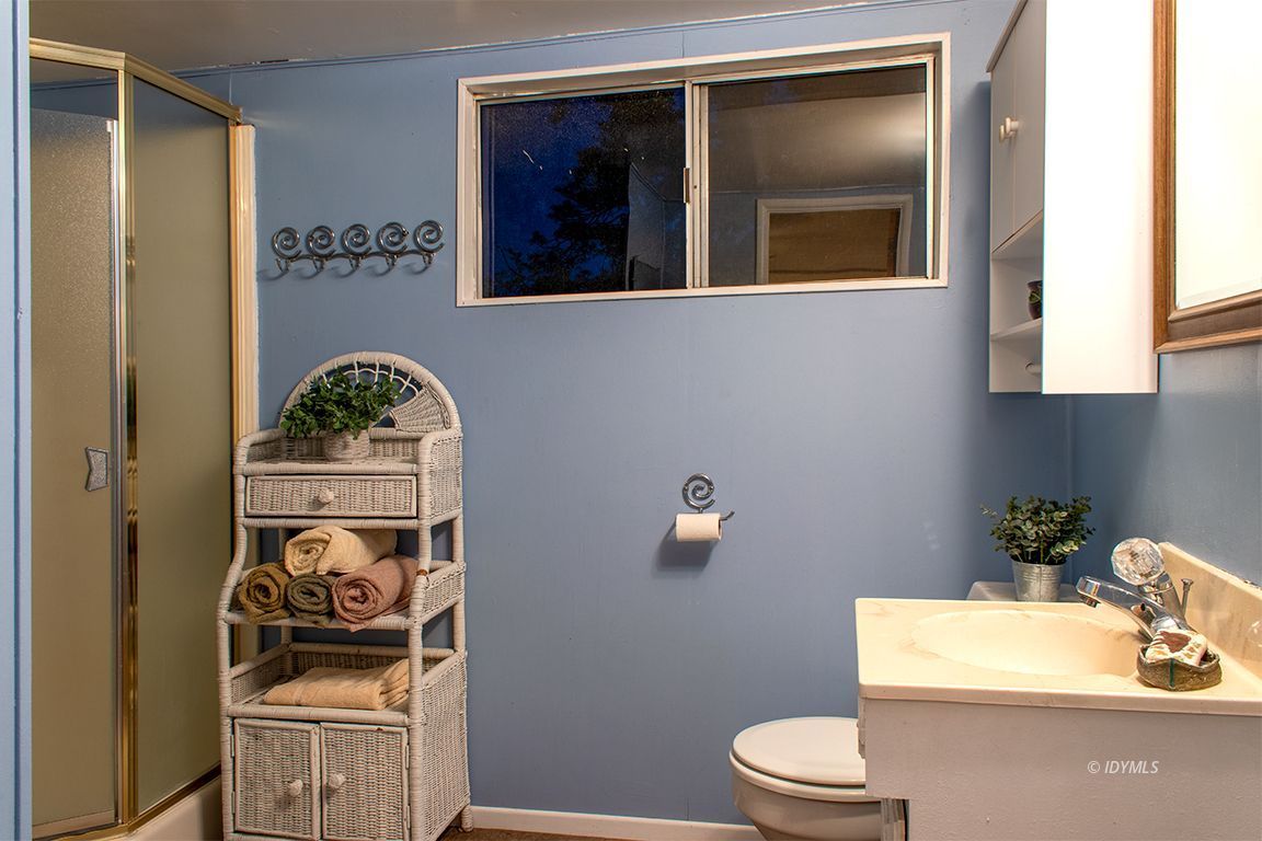 24730 High Grove Road Idyllwild, CA 92549 - Photo 17 of 24 a bathroom with a toilet a sink and mirror