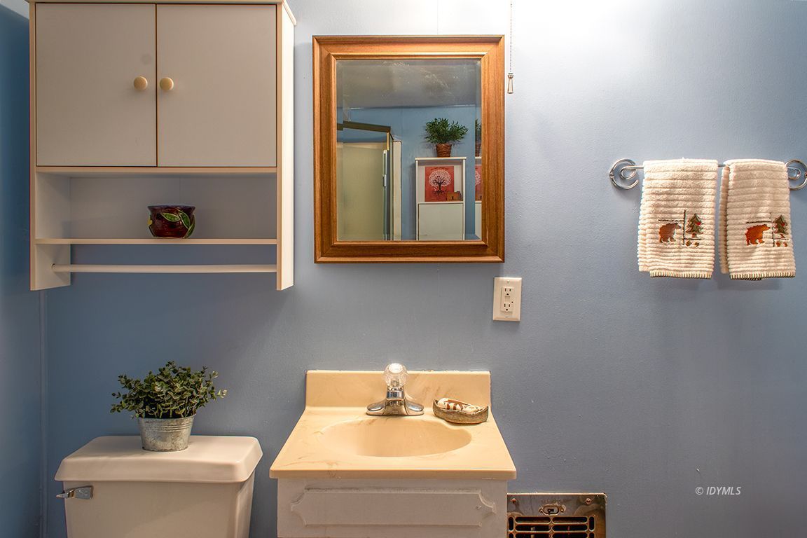 24730 High Grove Road Idyllwild, CA 92549 - Photo 19 of 24 a bathroom with a sink mirror and vanity
