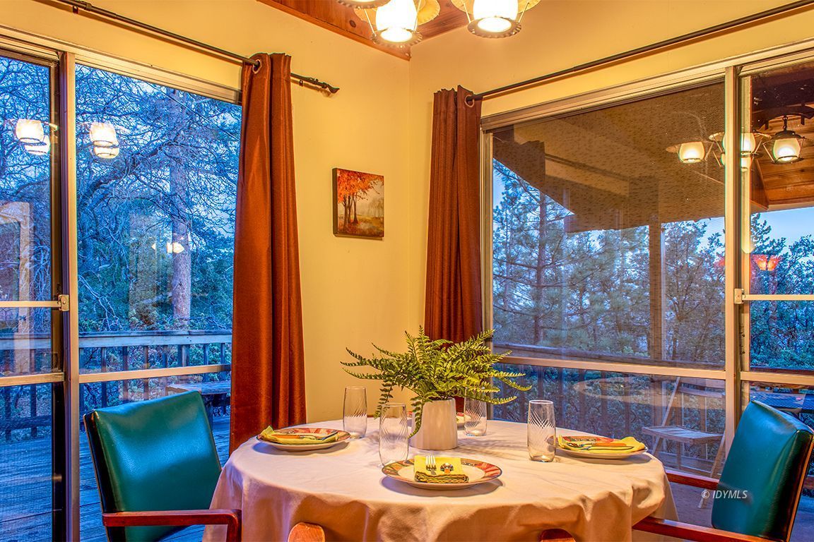 24730 High Grove Road Idyllwild, CA 92549 - Photo 6 of 24 a view of an outdoor dining space with a table and chairs