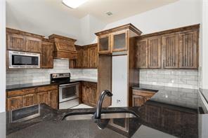 238 Rudder Road Gun Barrel City, TX 75156 - Photo 14 of 27 a kitchen with stainless steel appliances granite countertop a stove and a microwave