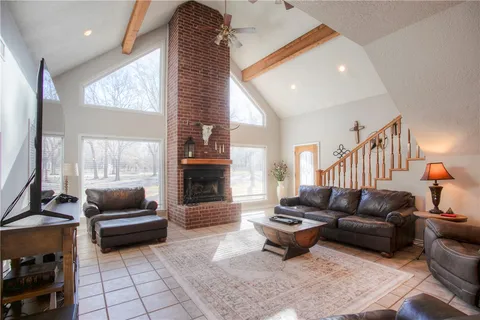 a kitchen with stainless steel appliances granite countertop a stove a sink a refrigerator and a wooden cabinets
