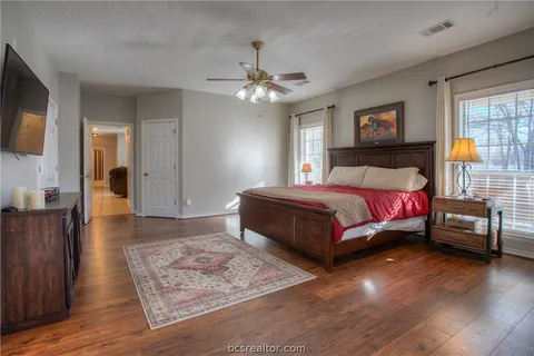a living room with furniture a ceiling fan and a window