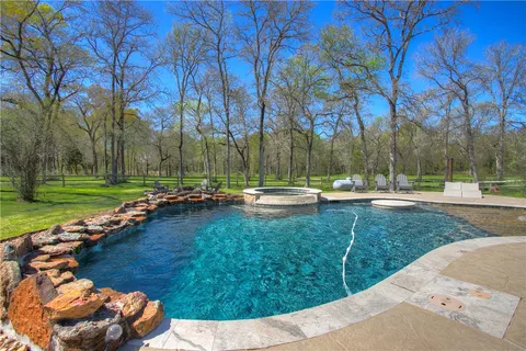 a view of a backyard with large trees