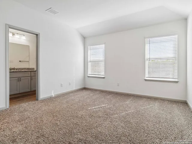an empty room with windows and closet