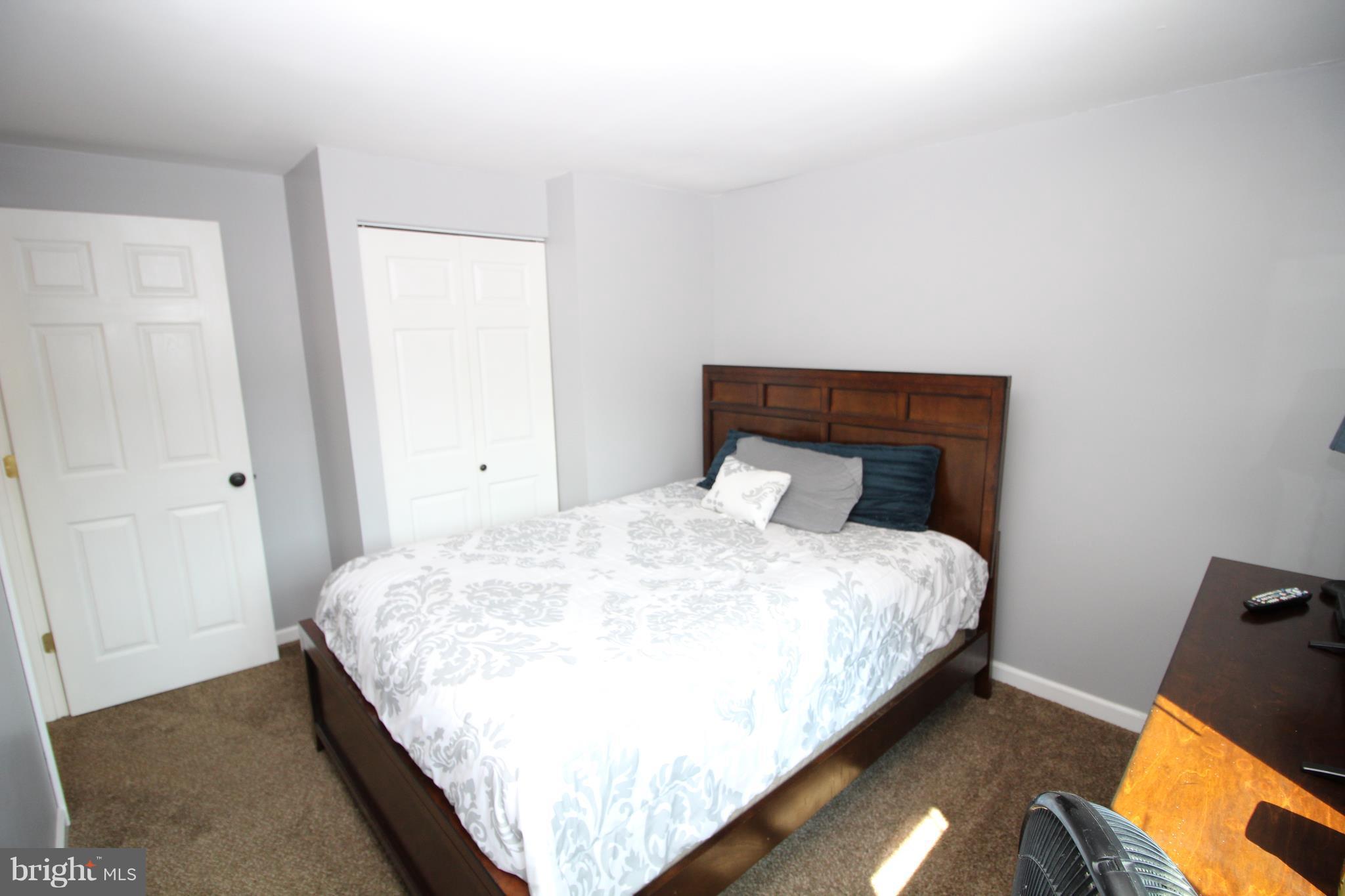 17667 Kohlhoss Road Poolesville, MD 20837 - Photo 14 of 27 a bedroom with a bed and wooden floor