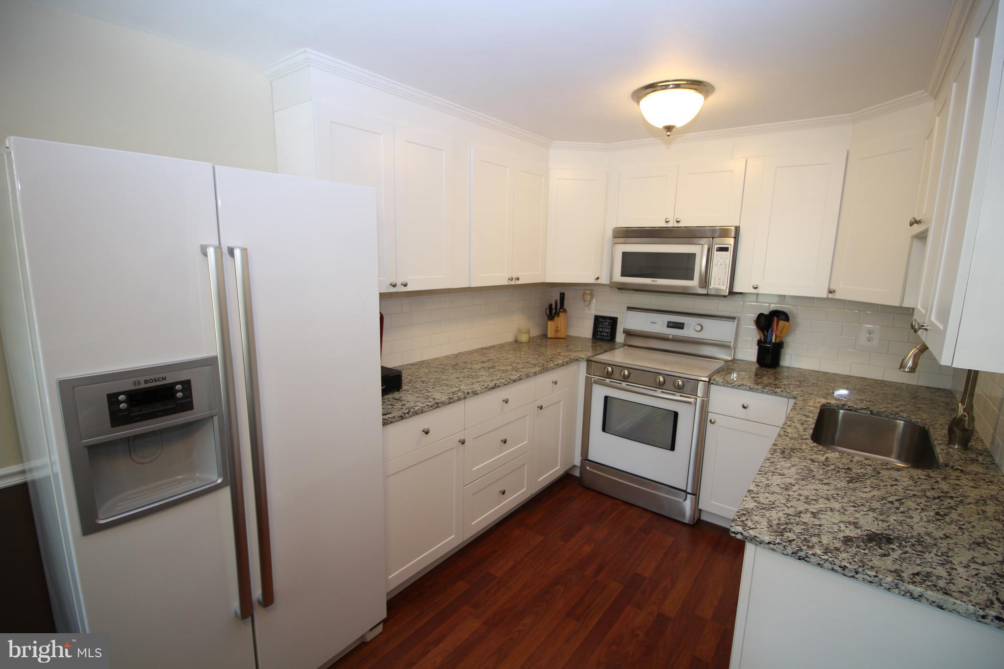 17667 Kohlhoss Road Poolesville, MD 20837 - Photo 5 of 27 a kitchen with cabinets stainless steel appliances and a counter space