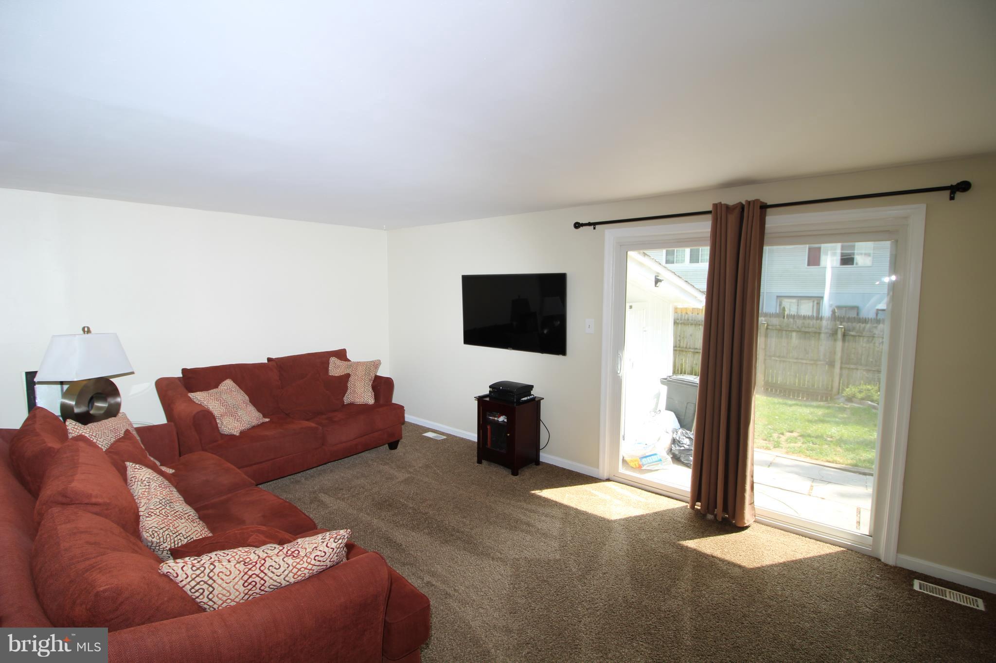 17667 Kohlhoss Road Poolesville, MD 20837 - Photo 7 of 27 a living room with furniture and a flat screen tv