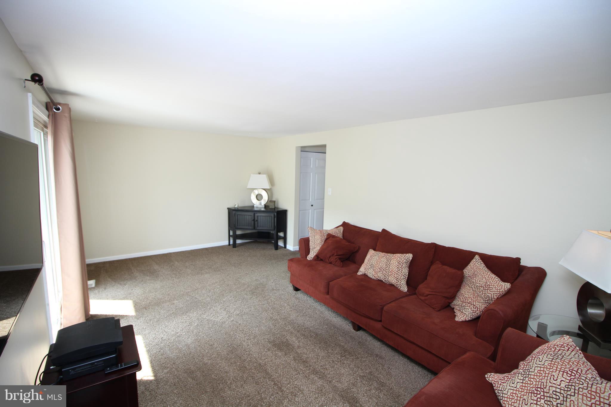 17667 Kohlhoss Road Poolesville, MD 20837 - Photo 8 of 27 a living room with furniture and a flat screen tv