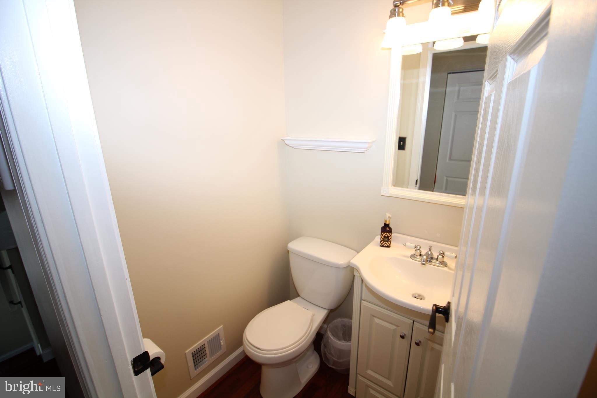 17667 Kohlhoss Road Poolesville, MD 20837 - Photo 9 of 27 a white toilet sitting next to a bathroom sink