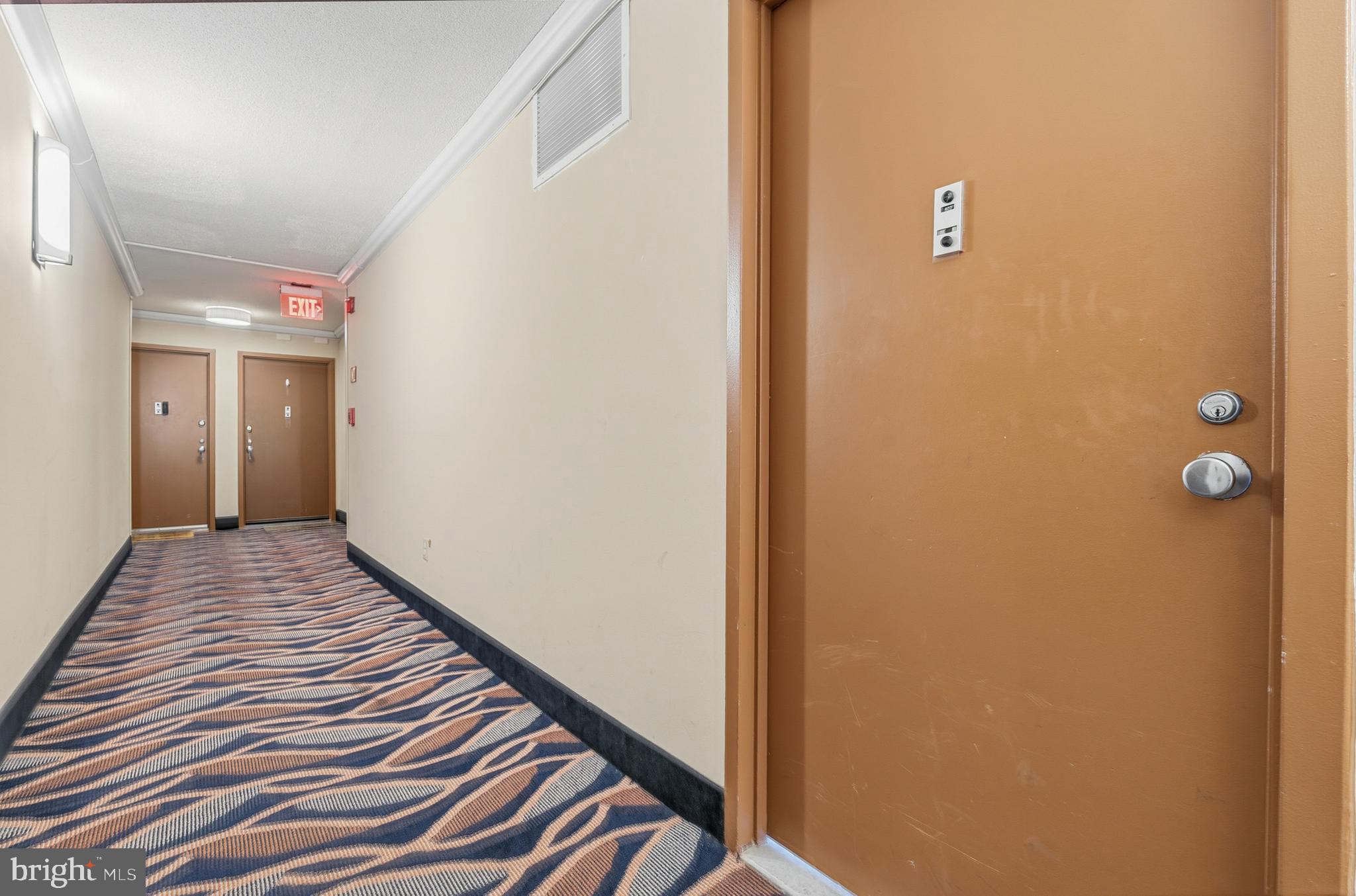 1121 University Boulevard West, Unit 1407B Silver Spring, MD 20902 - Photo 19 of 27 a view of a hallway with wooden floor