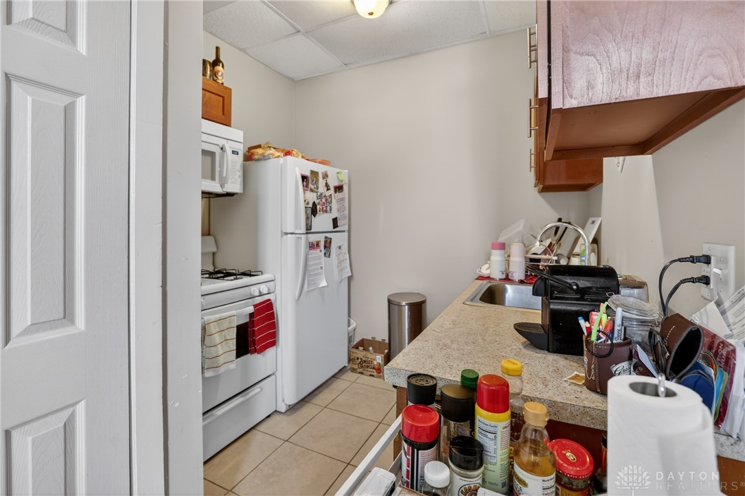 7045-7049 Montgomery Road Cincinnati, OH 45236 - Photo 33 of 68 This cozy kitchen features a practical layout with essential appliances and ample counter space.