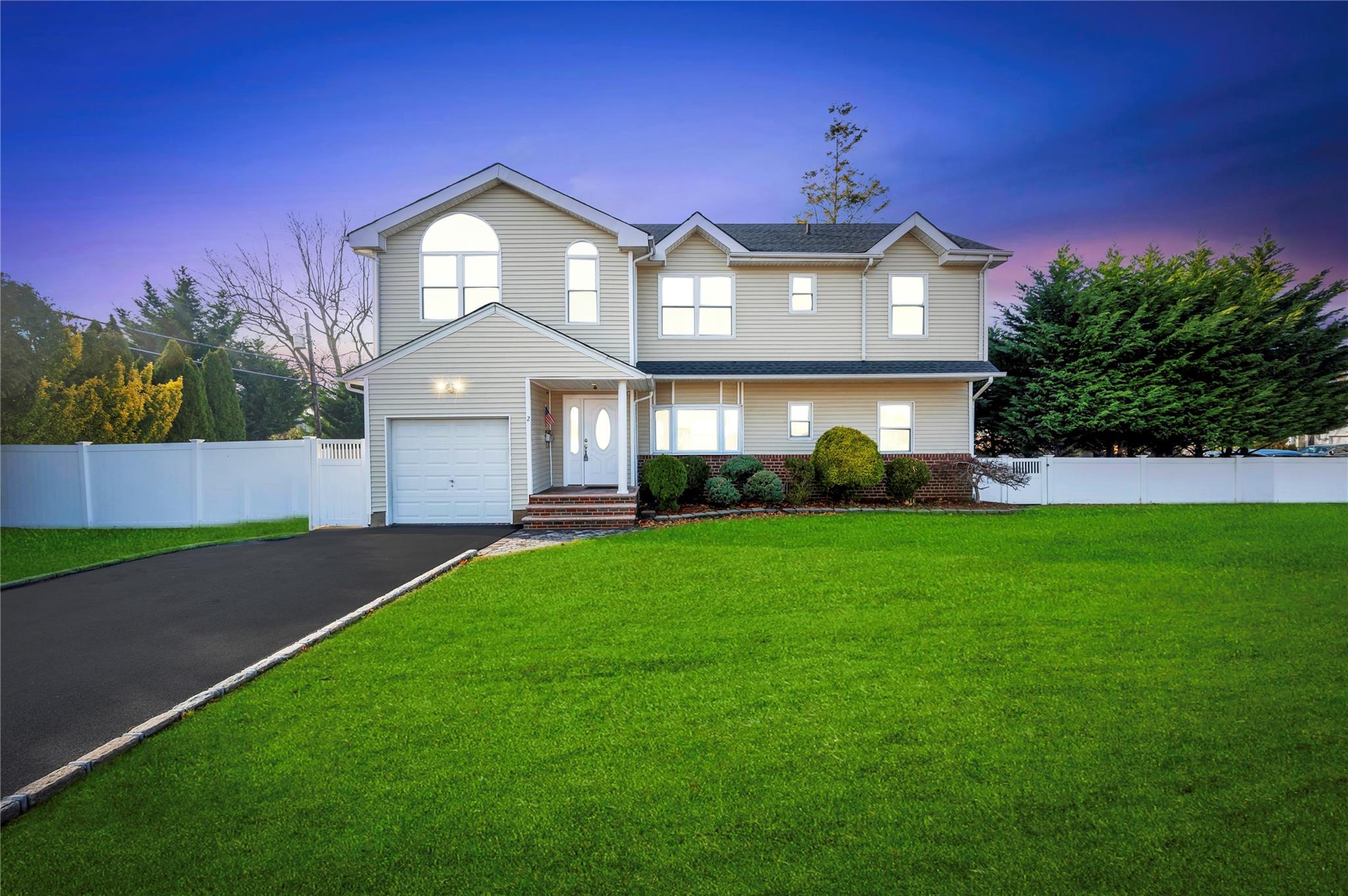 2 Cheshire Road Bethpage, NY 11714 - Photo 1 of 1 a front view of a house with a garden