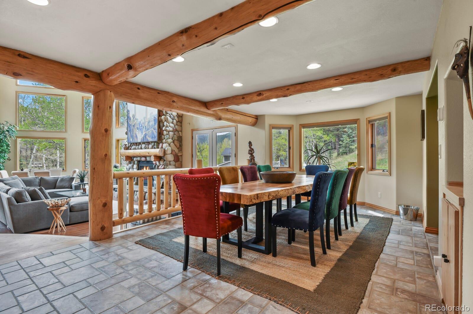 417 Witter Gulch Road Evergreen, CO 80439 - Photo 14 of 50 a view of a dining room with furniture window and outside view