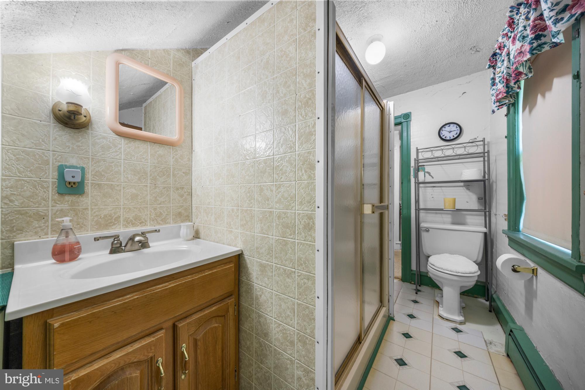 2137 Sicklerville Road Sicklerville, NJ 08081 - Photo 27 of 32 a bathroom with a sink a toilet and shower