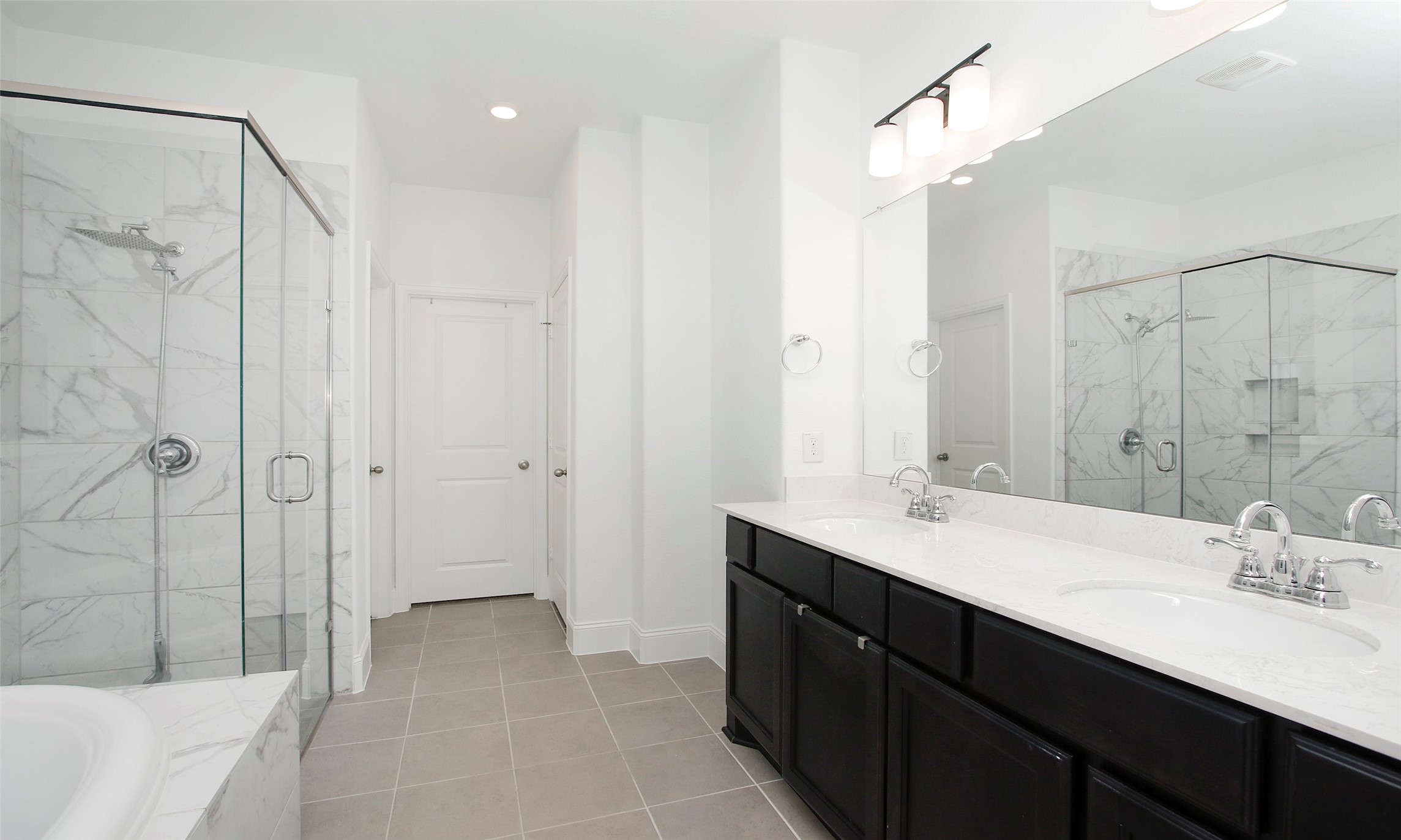 2741 Altissimo Court Spring, TX 77386 - Photo 13 of 30 The primary bathroom includes an oversized soaking tub situated next to a separate glass-walled shower, perfect for relaxing after a long day!