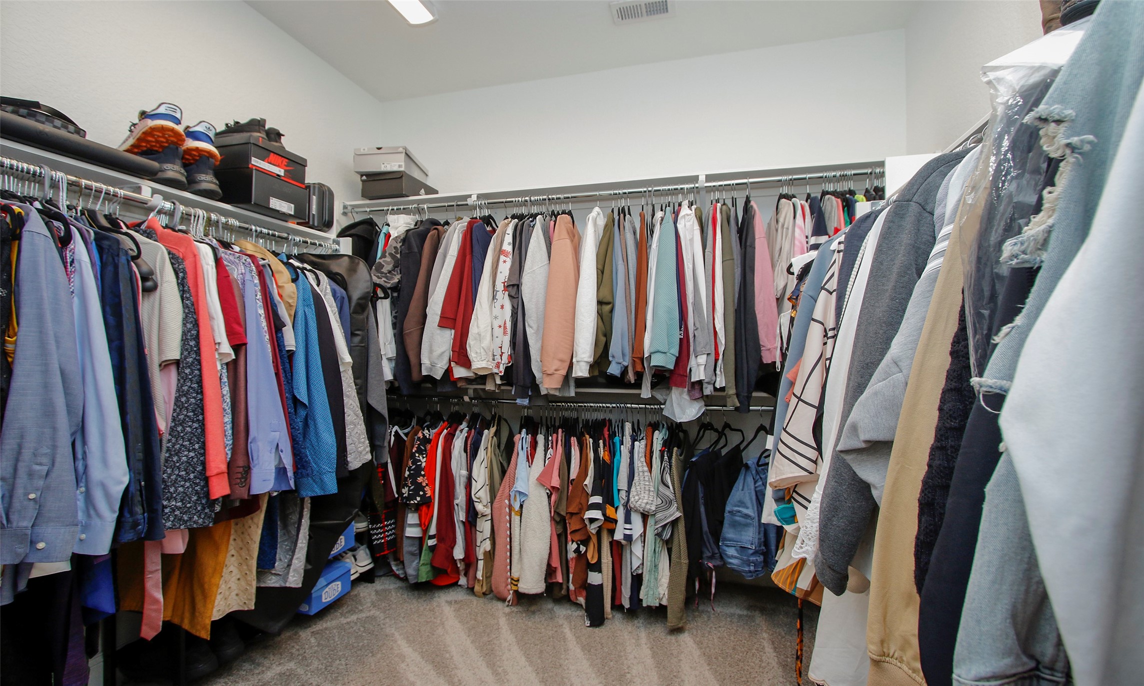 2741 Altissimo Court Spring, TX 77386 - Photo 16 of 30 Primary closet features extensive storage with built-in shelving and double-hanging rods to maximize organization!