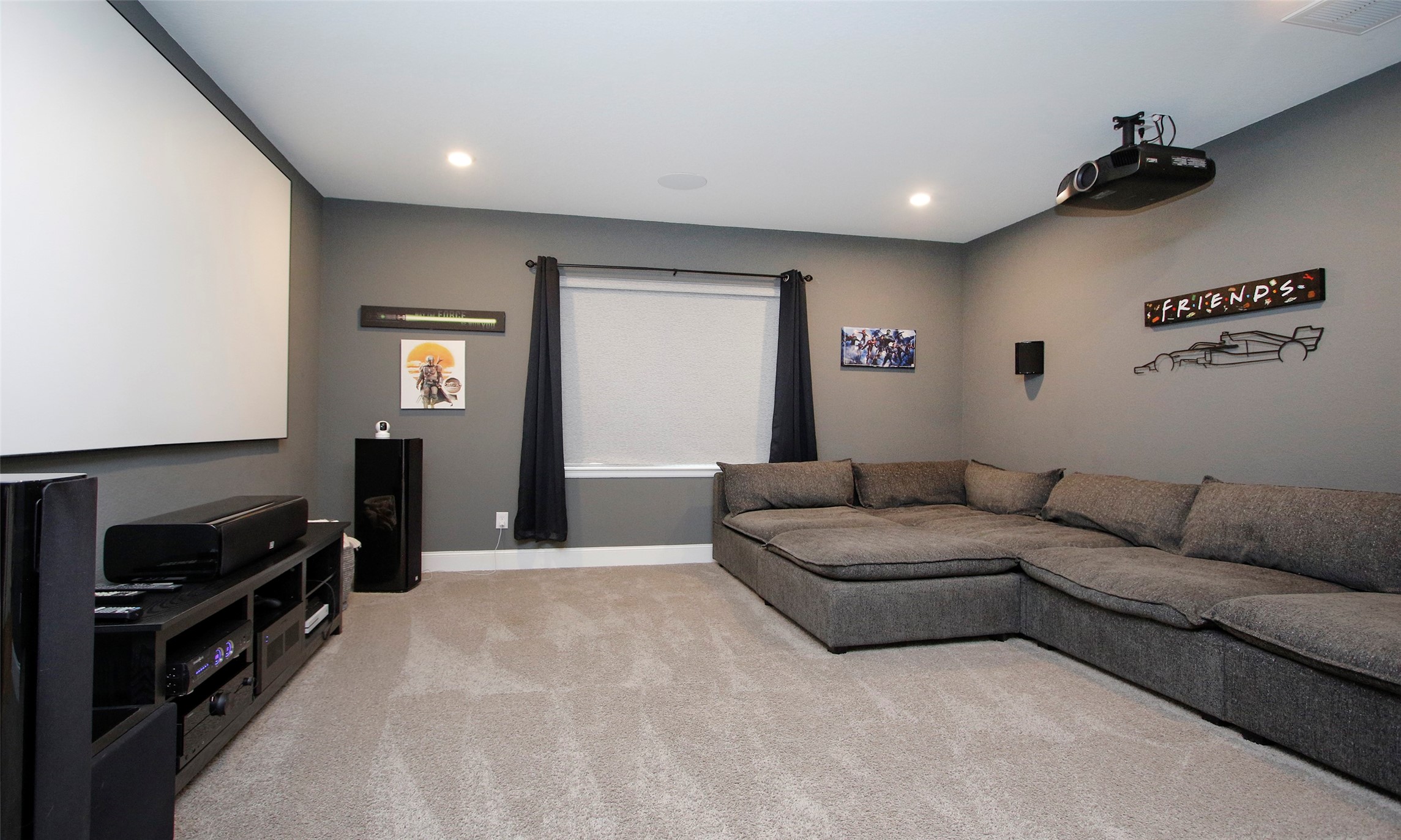 2741 Altissimo Court Spring, TX 77386 - Photo 17 of 30 The media room is conveniently located on the first floor and features dark-toned walls with carpet flooring.
