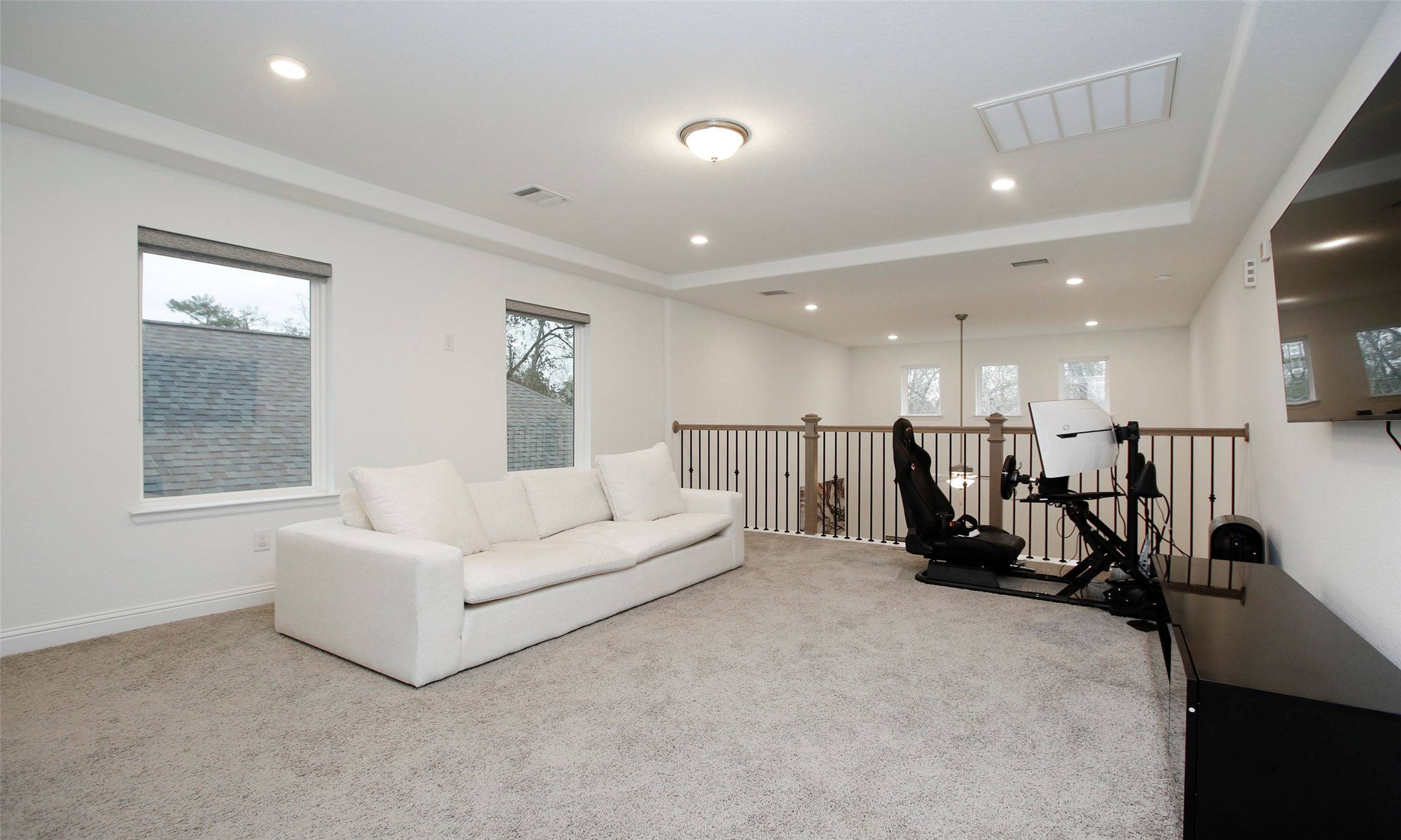 2741 Altissimo Court Spring, TX 77386 - Photo 21 of 30 Different view of the game room with recessed lighting and neutral-toned carpeting! Notice the open spindle railing that overlooks the first floor!