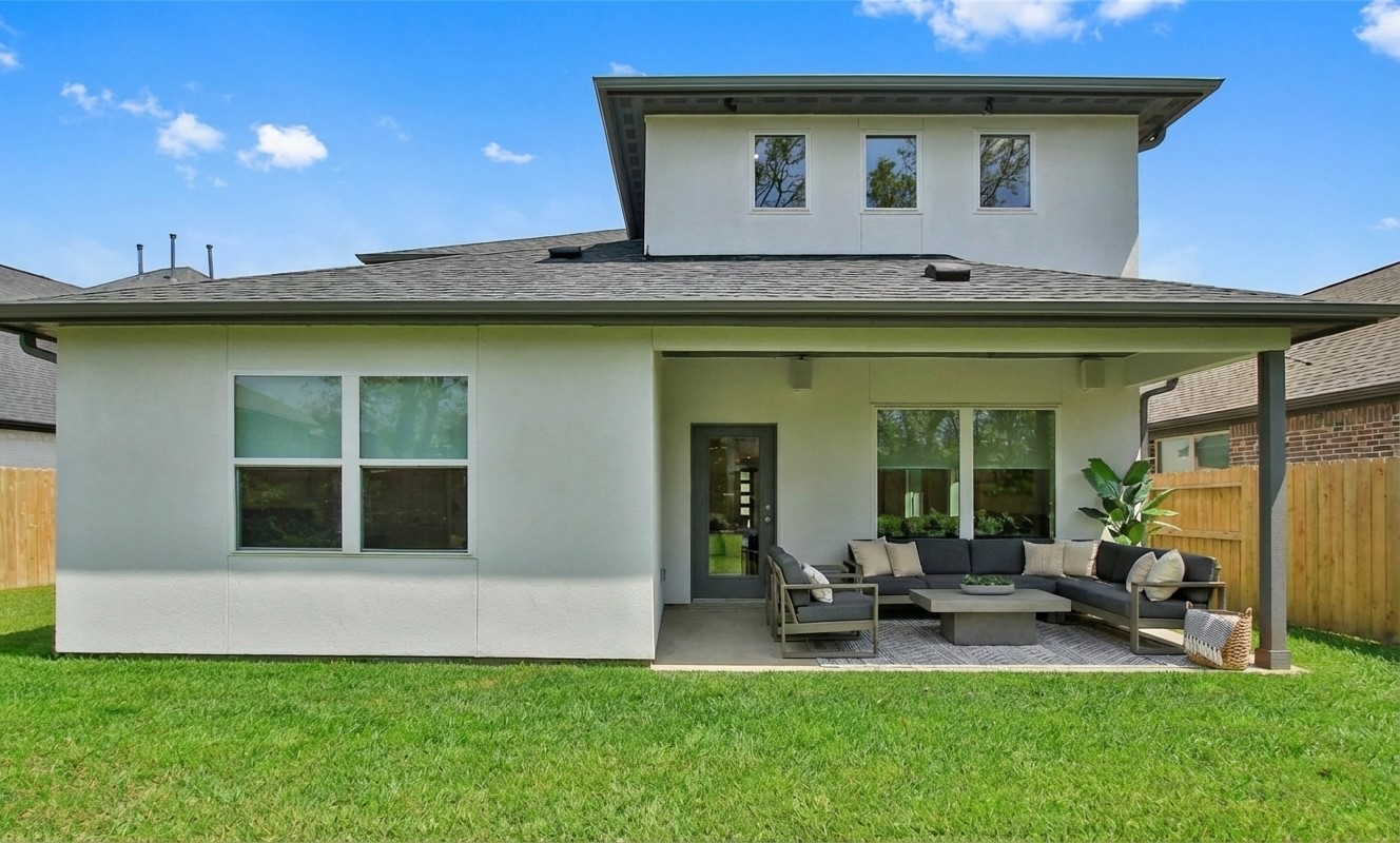 2741 Altissimo Court Spring, TX 77386 - Photo 25 of 30 This covered outdoor patio provides a spacious area for lounging and entertaining, overlooking a private, fenced backyard with a well-maintained lawn. *photo is virtually staged*