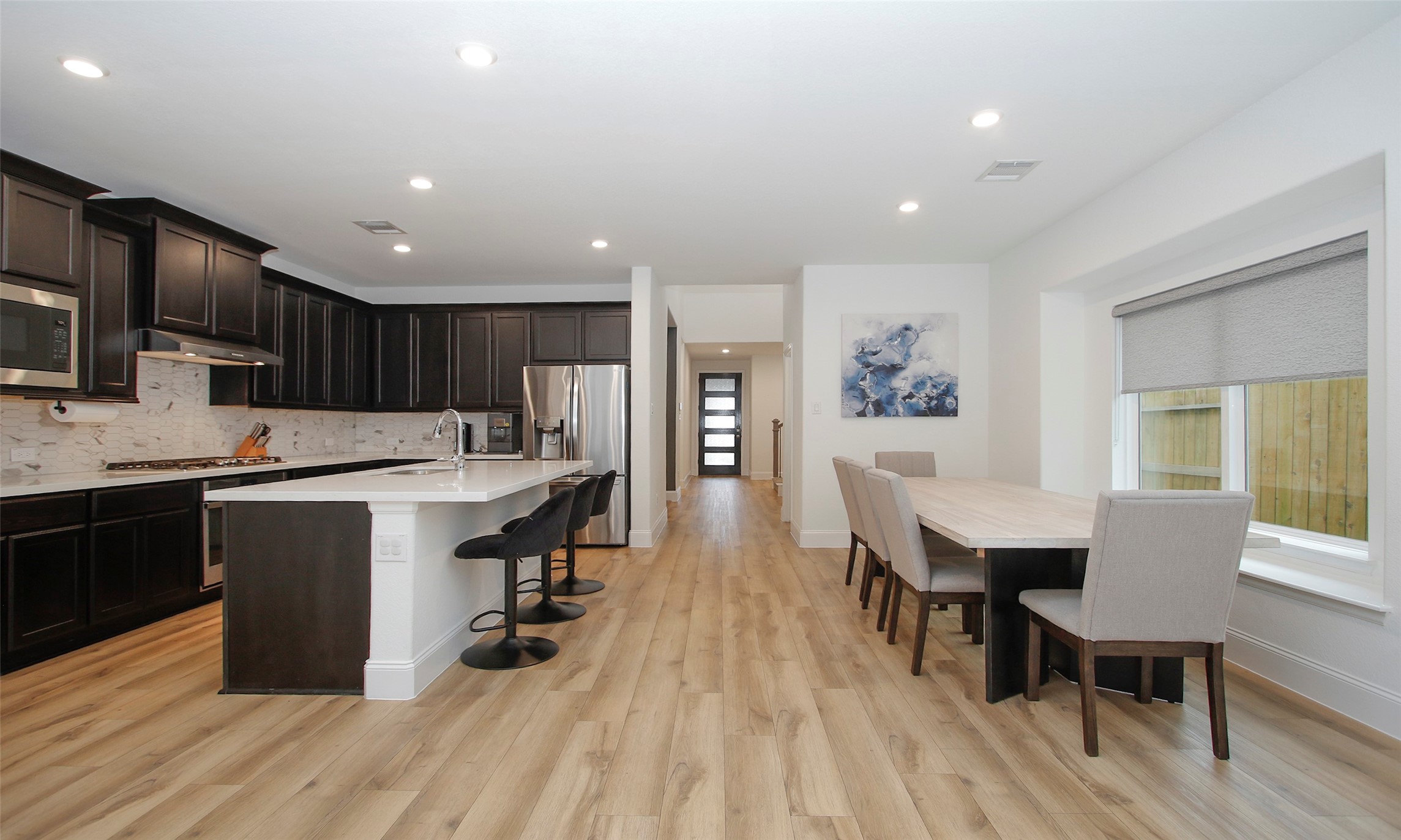 2741 Altissimo Court Spring, TX 77386 - Photo 9 of 30 Look at how this open-concept space connects the kitchen to a bright dining area with a large window offering side yard views!